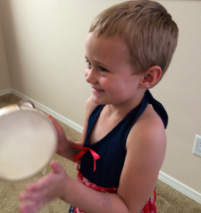 girl playing tamborine